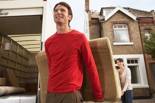Staff wearing PPE while loading belongings into a van