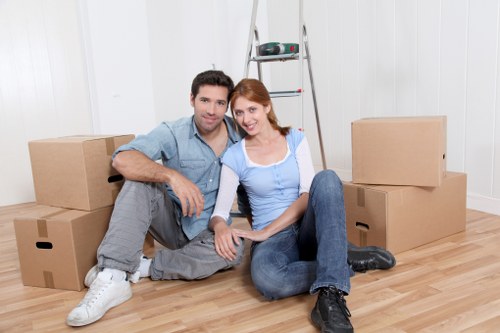 Movers handling boxes and desks during a business relocation