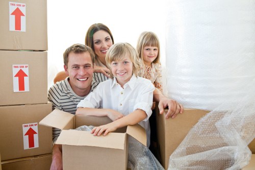 Professional movers carrying furniture through a flat with stair access